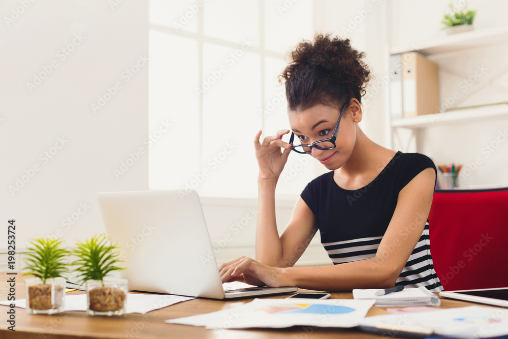 Happy business woman working on laptop at office Happy business woman working on laptop at office