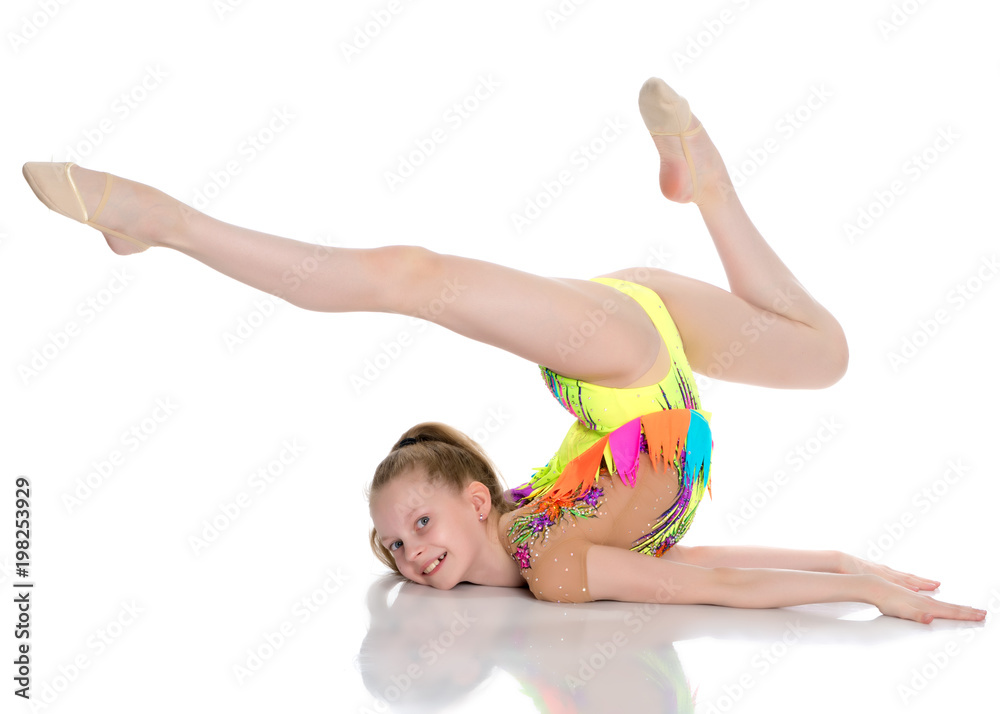 The gymnast performs an acrobatic element on the floor. The gymnast performs an acrobatic element on the floor.