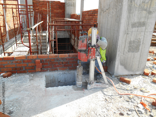 Photography KUALA LUMPUR, MALAYSIA -DECEMBER 06, 2016: Concrete coring work by construction worker