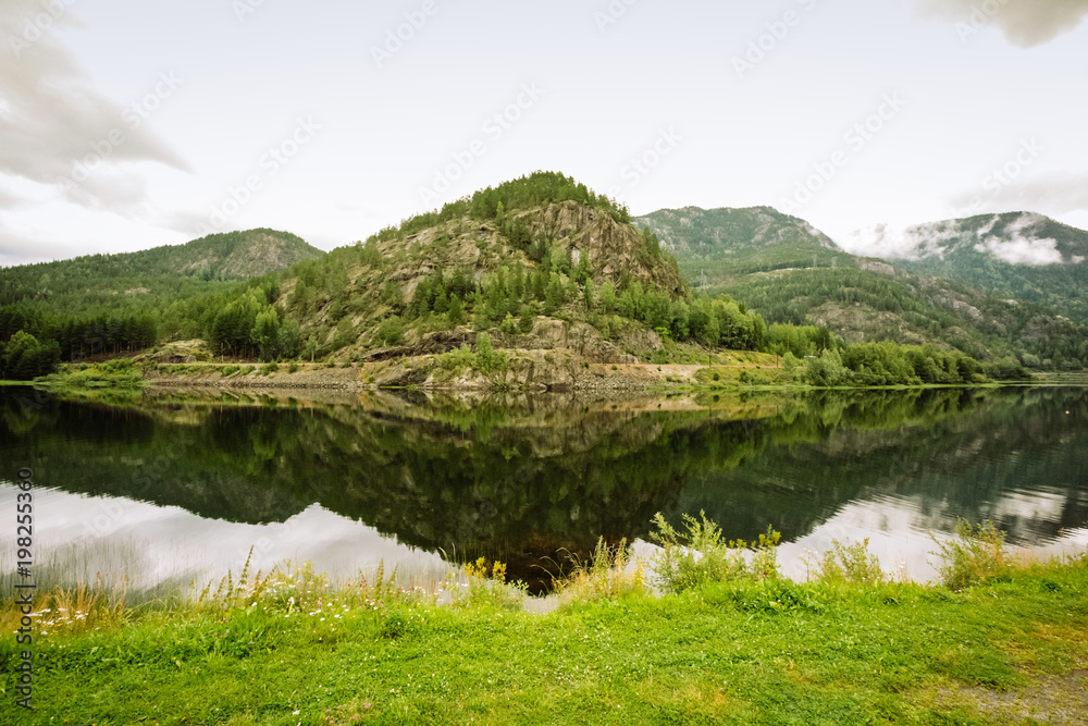 Summer Norwegian mountain landscape reflected in water