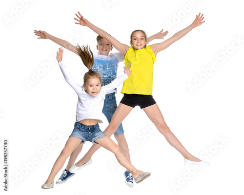 A group of children jumping and waving.