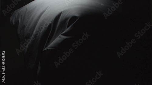 Black Cloth Floating down on a stark backdrop. Abstract footage of black cloth floating down.