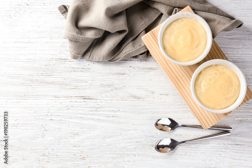 Fototapete Bowls with vanilla pudding on wooden background