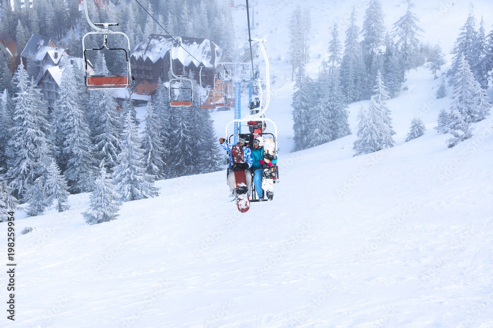 Couple on ski lift at mountain resort. Winter vacation Couple on ski lift at mountain resort. Winter vacation