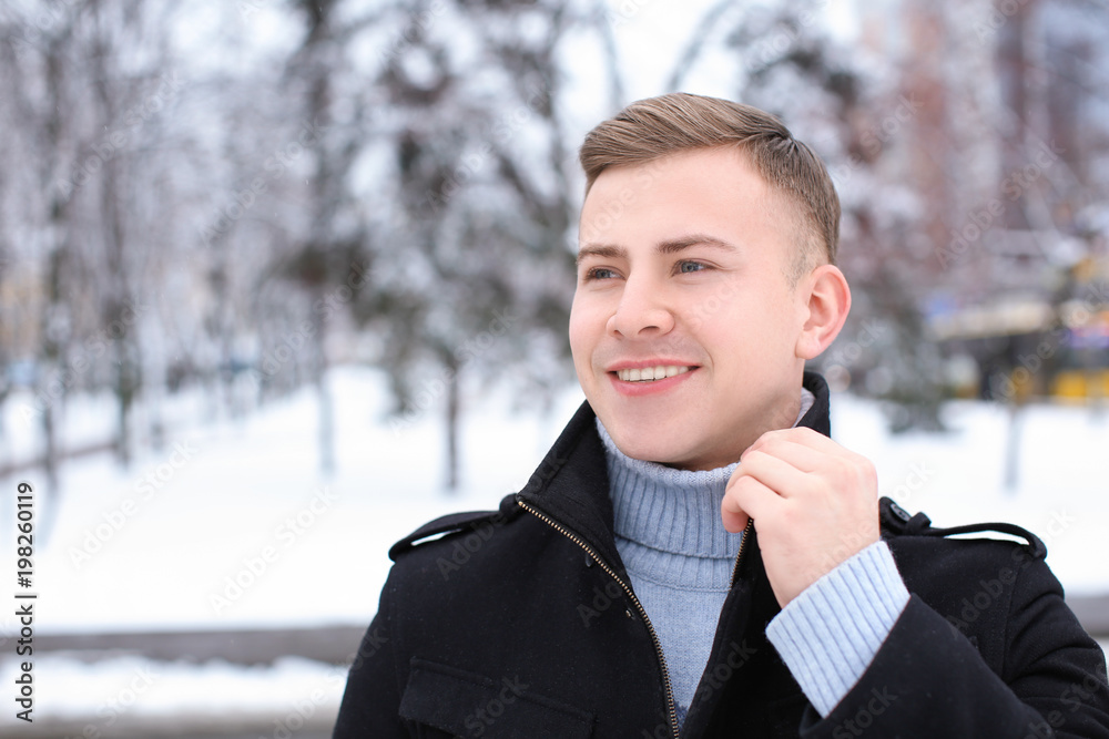Portrait of happy young man in snowy park on winter vacation Portrait of happy young man in snowy park on winter vacation
