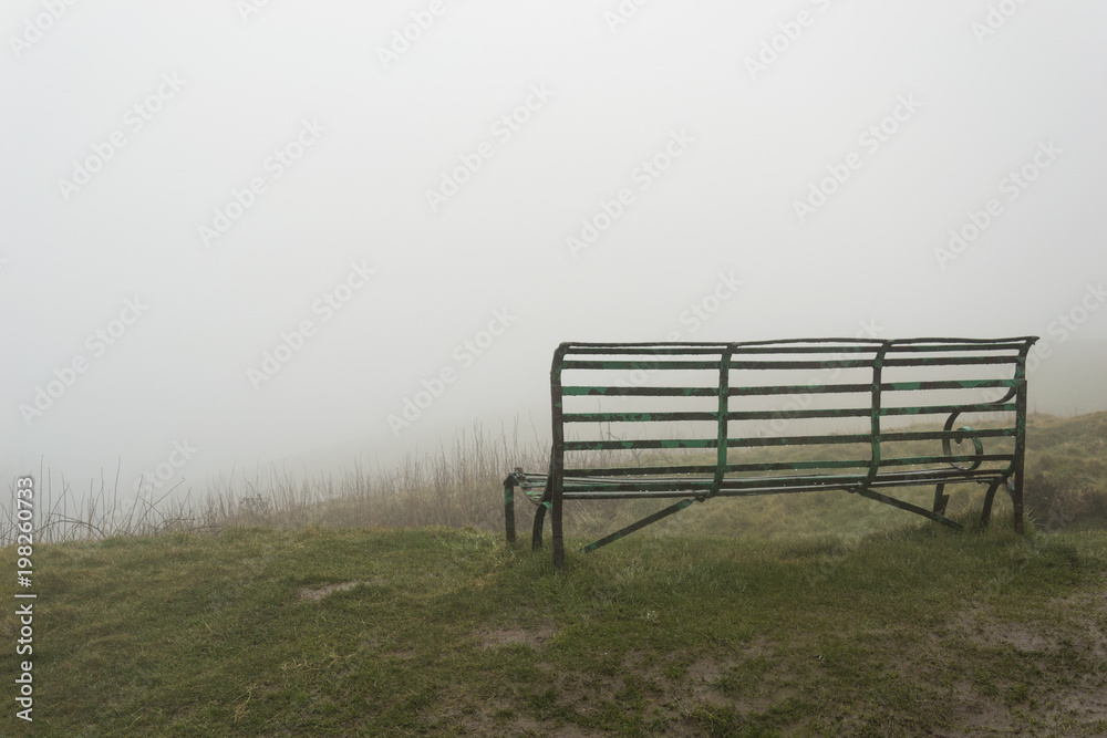 Green metal bench on the Malvern Hills Worcestershire Green metal bench on the Malvern Hills Worcestershire
