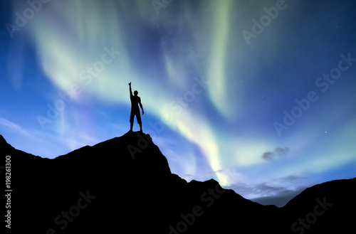 Silhouette of a winner on the northen light backgroun. Concept and idea of active life photo