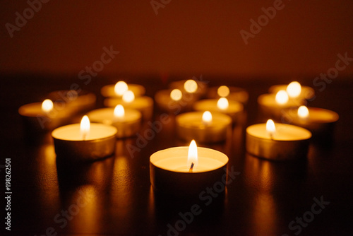 Kemerovo  Russia  fire in the mall  burning candles. Shallow depth of field. Many candles burning at night. Candles background. Many candle flames glowing on dark background. Close-up. Free space.