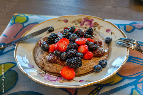 Pancakes for breakfast with berries and jam