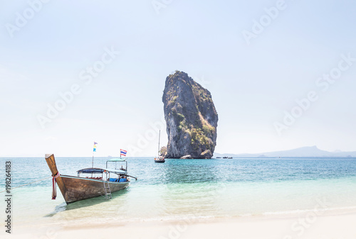  Longtail boat mooring on the tropical beach with limestone rock symbol of Poda island is popular tourist destinations in the andaman sea krabi Thailand in sunny day