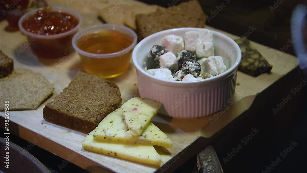 A close up shot of a very delicious cheese platter.