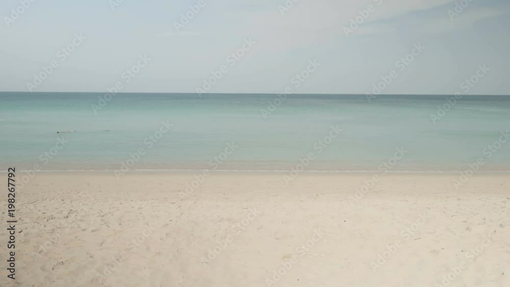 Happy couple playing with frisbee flying disc on the beach during sunny summer day Happy couple playing with frisbee flying disc on the beach during sunny summer day