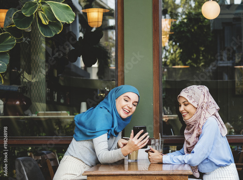 Photography Islamic friends talking and looking on the smart phone