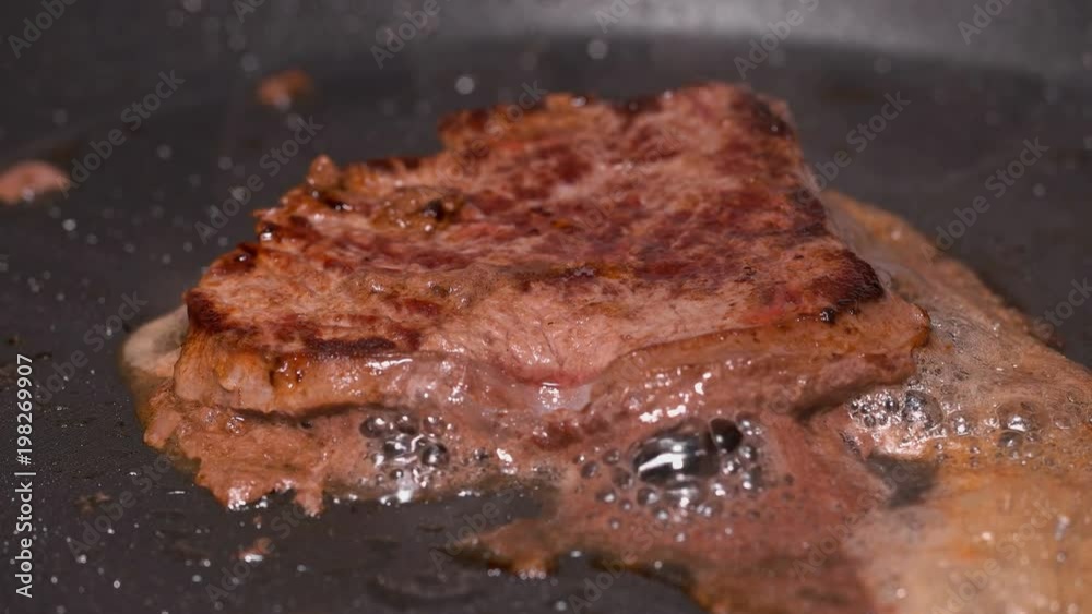 pieces of meat fried in a frying pan, close up
