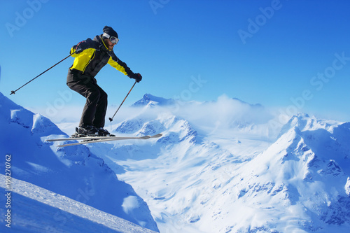 Jumping skier at mountains