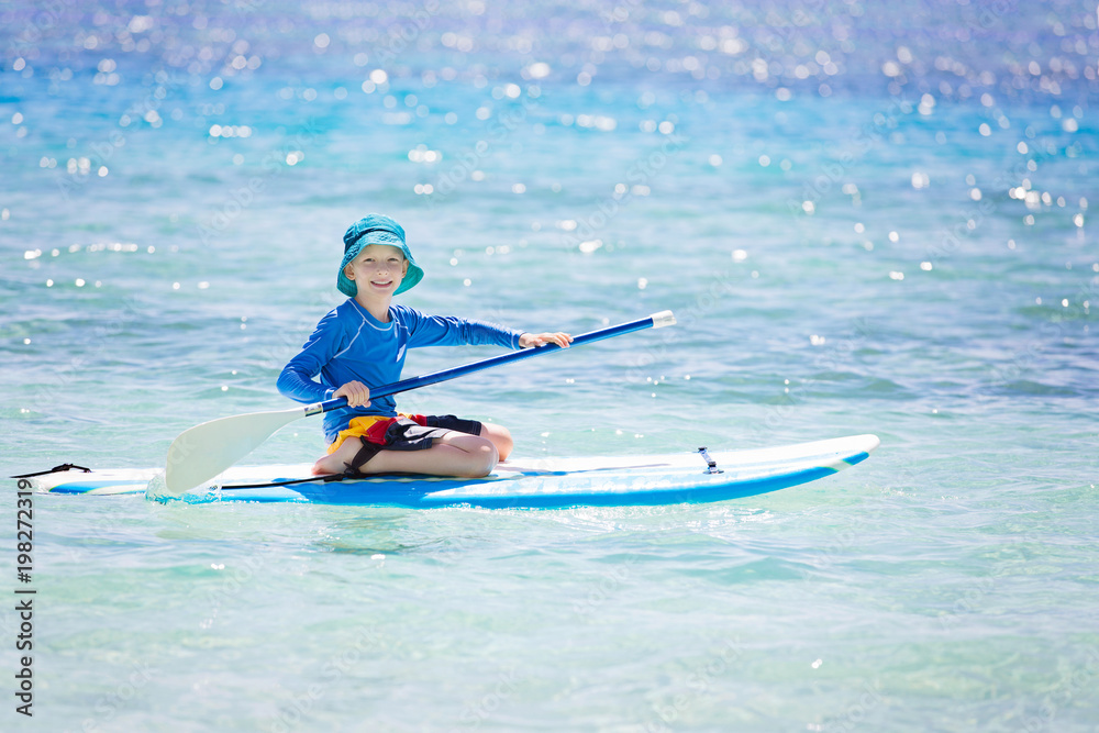 kid stand up paddleboarding