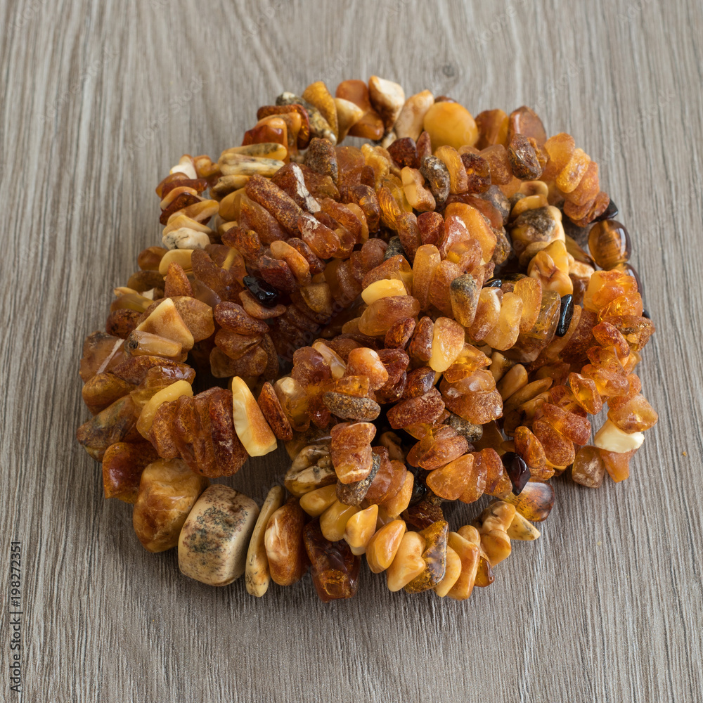 Obraz premium Necklace made of Baltic amber is composed of a slide. Amber is not large, yellow and brown. Beads made of natural amber.