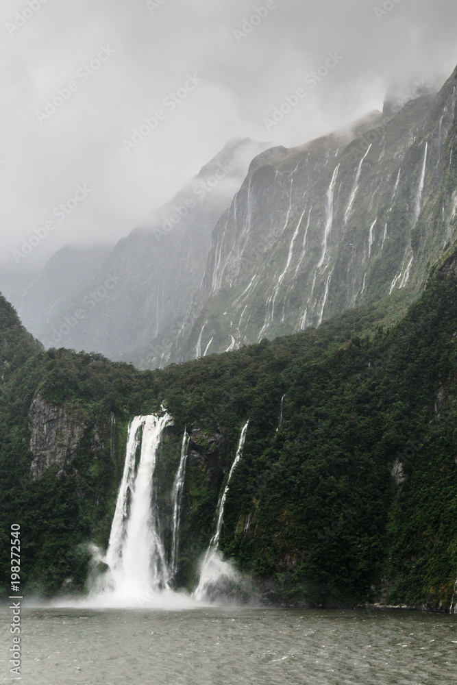 Stirling Falls in Milford Sound, New Zealand, with mountains in background
