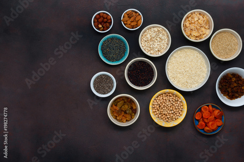Flat lay different superfood, seeds and cereal on dark background with copy space, top view. Flat lay. Set vegetarian healthy Clean food