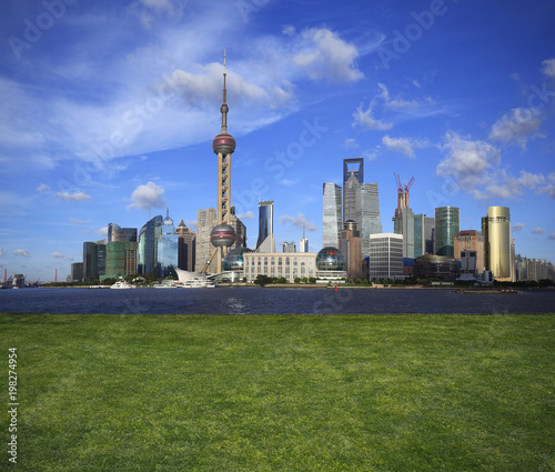 Empty green grass lawns with Shanghai skyline