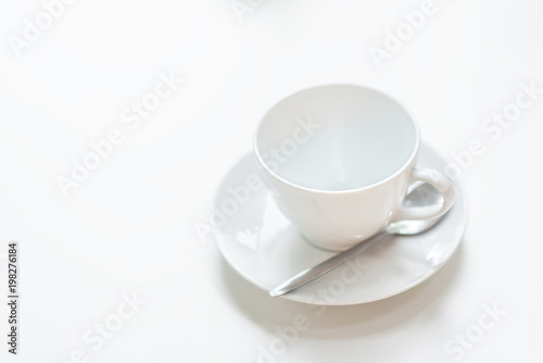 Ceramic coffee cup on the white table