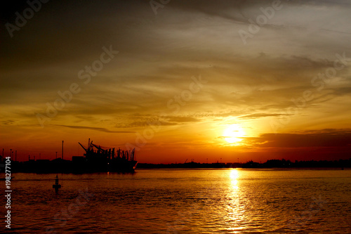 silhouette of a cargo ship on the sea