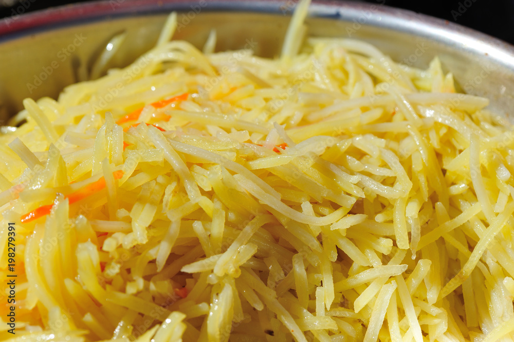 cooked sliced potato and carrots in container cooked sliced potato and carrots in container
