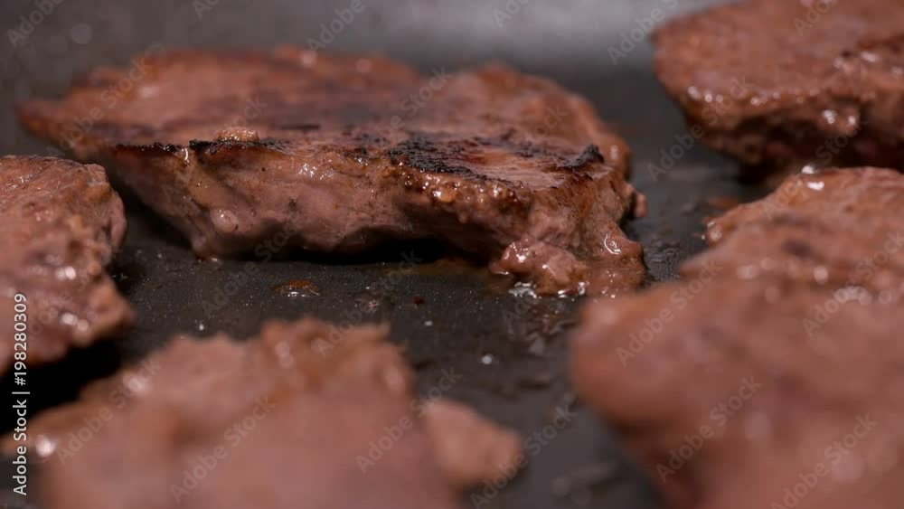 pieces of meat fried in a frying pan, close up pieces of meat fried in a frying pan, close up