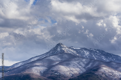 Snowy peak mountain on a deep cloudscape landscape
