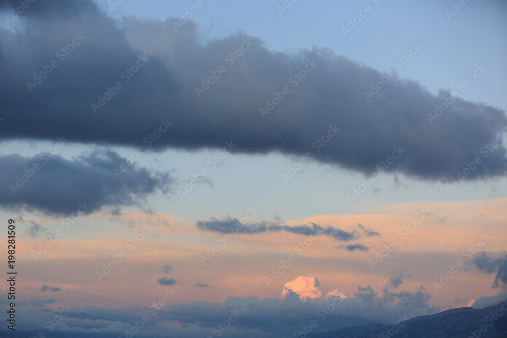 clouds over high altitude mountains during sunrise