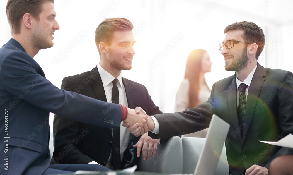 Partners concluding deal and shaking hands in the presence of te Partners concluding deal and shaking hands in the presence of te