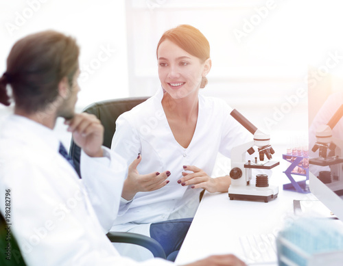 Side view of two scientists conducting a chemical experiment