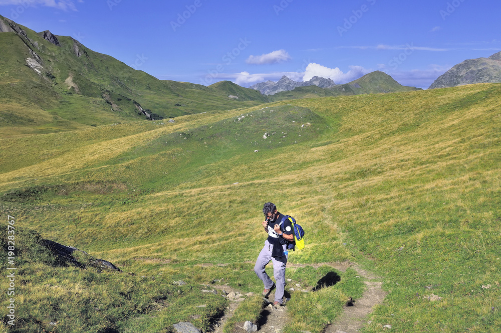 hiker walking in greenery hills