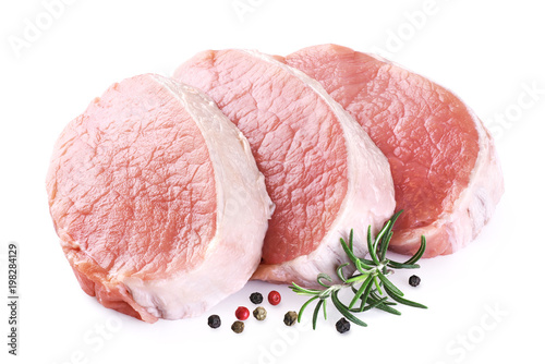 Raw sliced pork loin with pepper and rosemary isolated on white background. Fresh meat.