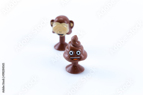 Funny angry poop and monkey covering face emoticon smiles isolated in white background
