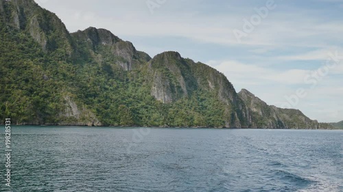 View from a moving ferry. The Busanga Mountains. Tropical landscape of the Palawan Islands. The city of Coron. Philippines. photo