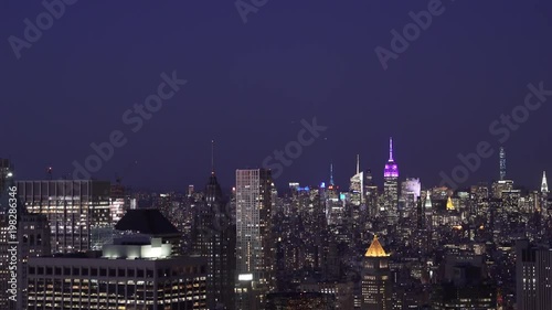 Wallpaper Mural New York City low flying telephoto aerial view at night of Lower Manhattan Financial District office buildings with the Midtown Skyline in the background. Torontodigital.ca
