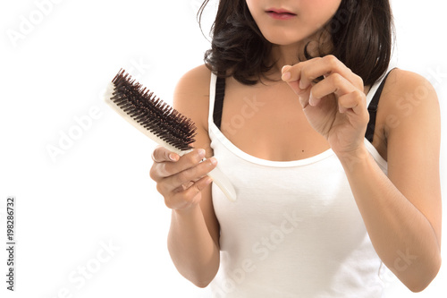 Portrait of asian woman long hair with a comb and problem hair on white background, Free form copy space.This image for hair loss concept.