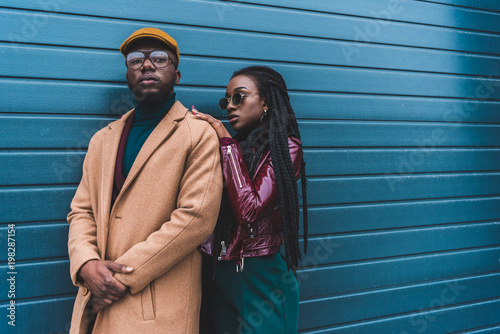 фотографія beautiful african american couple in fashionable outfit posing together outside