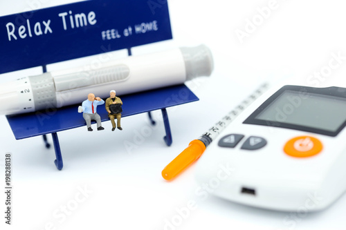 Miniature people : people sitting on chair with Diabetes blood glucose test with Syringe,Healthcare concept.