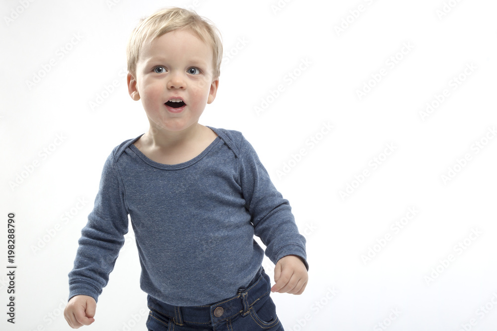 excited open mouthed two years toddler on the white background. copy space excited open mouthed two years toddler on the white background. copy space