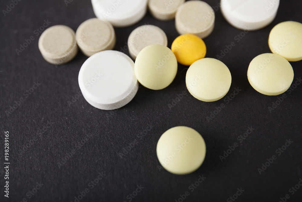 Tablets and capsules are scattered on the table Tablets and capsules are scattered on the table