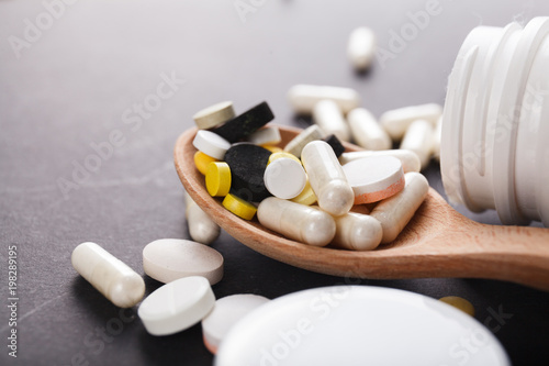 Tablets and capsules are scattered on the table
