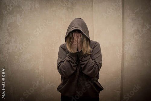 Hopeless drug addict holding his head. portrait of young person with substance dependence