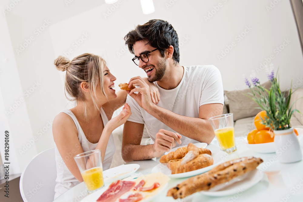 Cute young couple enjoying their breakfast together