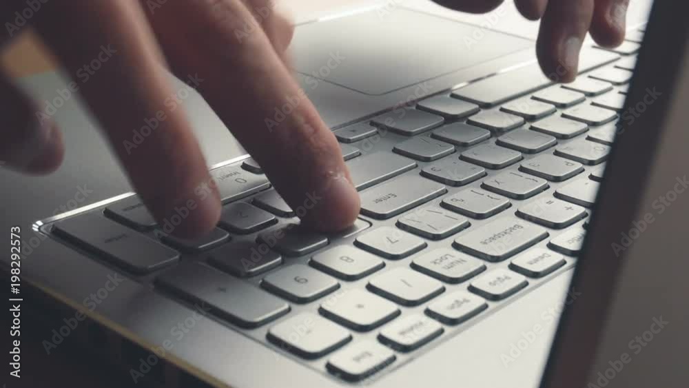 Laptop keyboard typing. Close up shot of hands touch typing on a laptop keyboard