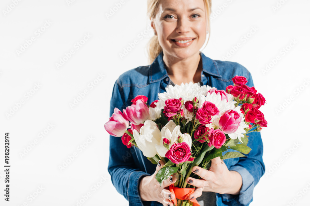 Blonde woman holding bouquet of flowers isolated on white Blonde woman holding bouquet of flowers isolated on white