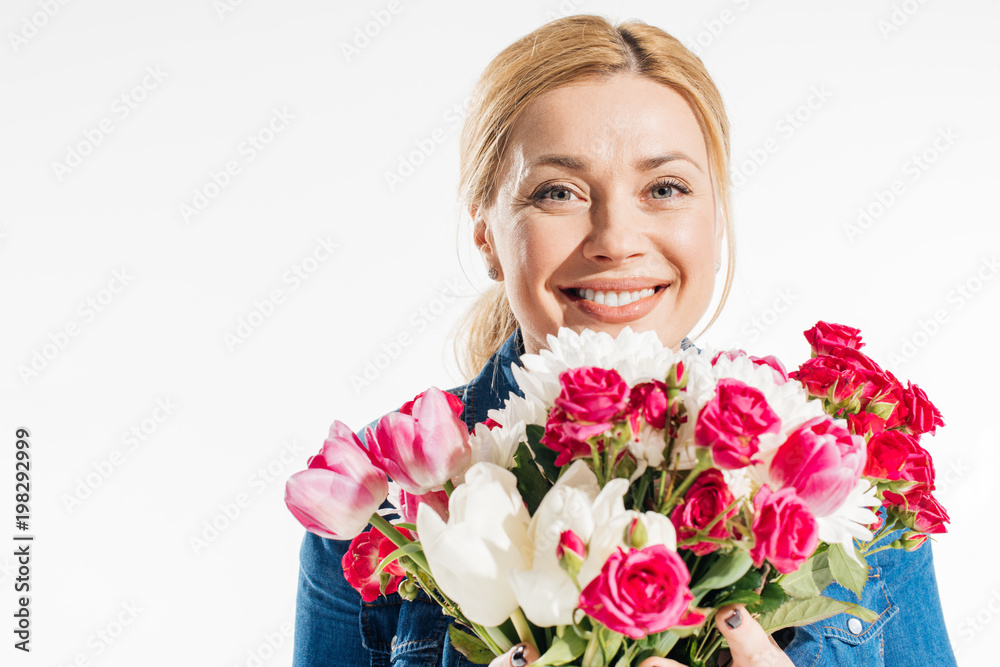 Happy woman holding bouquet of spring flowers isolated on white