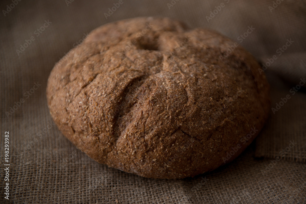 Rustic loaf bread on heavy fabric Rustic loaf bread on heavy fabric