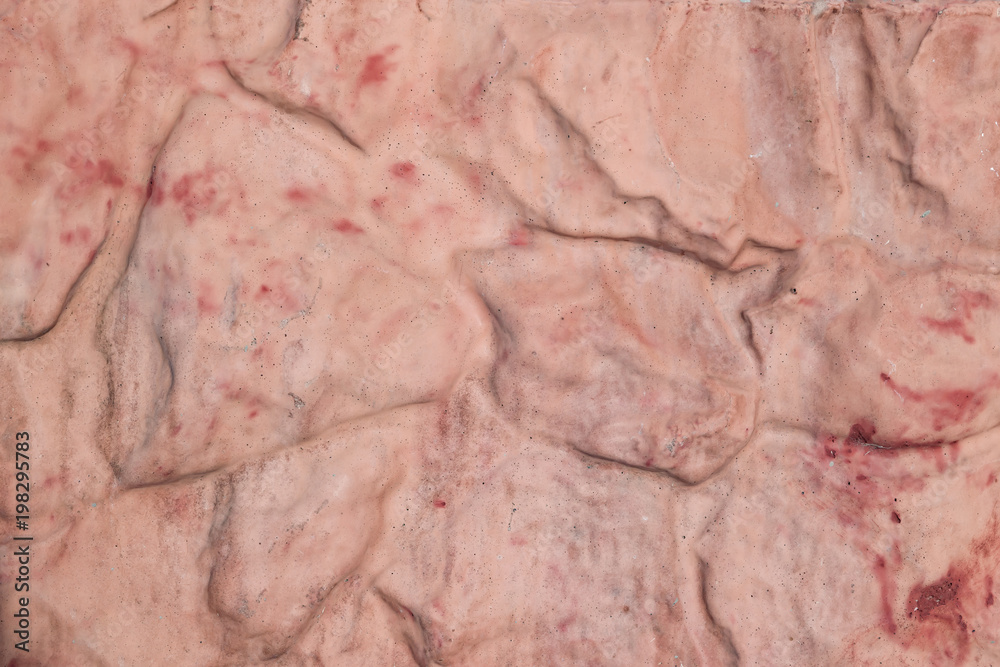 Texture of uneven stones painted with red and beige paint with streaks, abstract background Texture of uneven stones painted with red and beige paint with streaks, abstract background